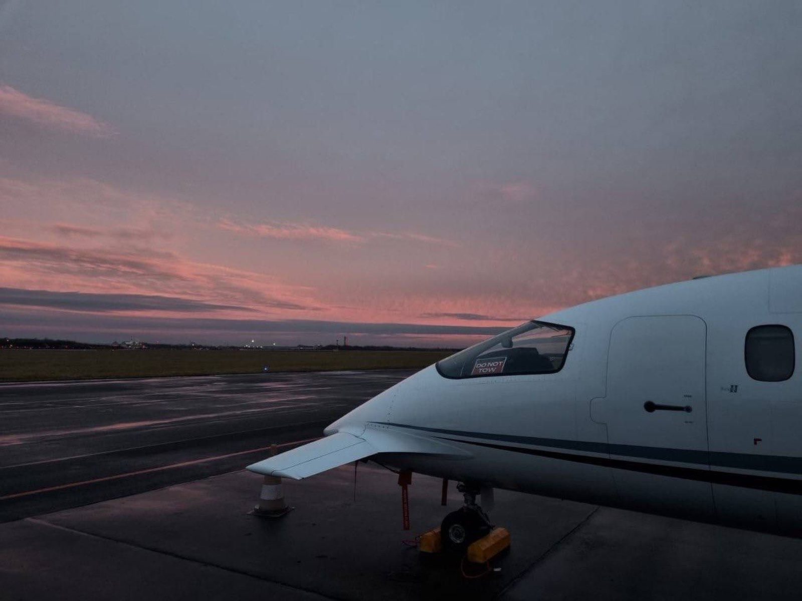 Piaggio Avanti nose and cockpit at first light on a wet ramp