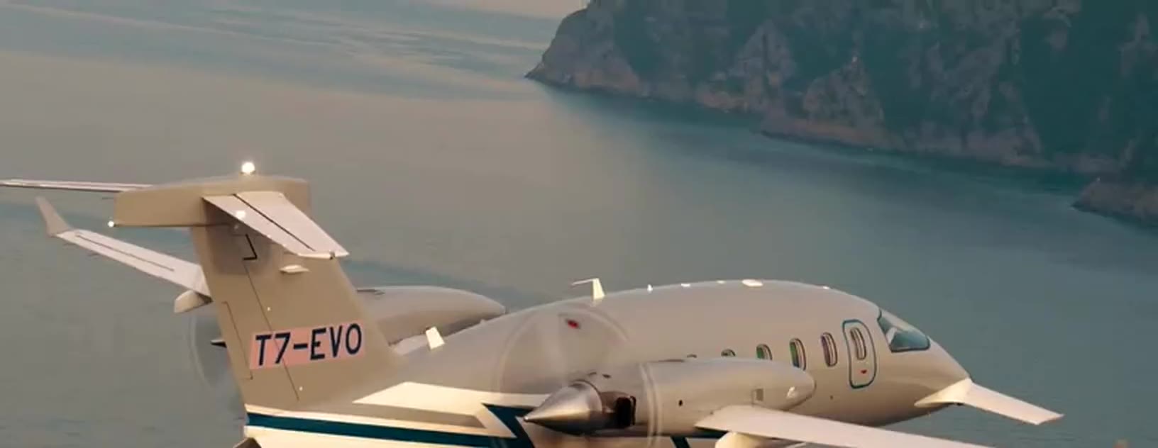 Piaggio P.180 Avanti EVO in flight over the coast