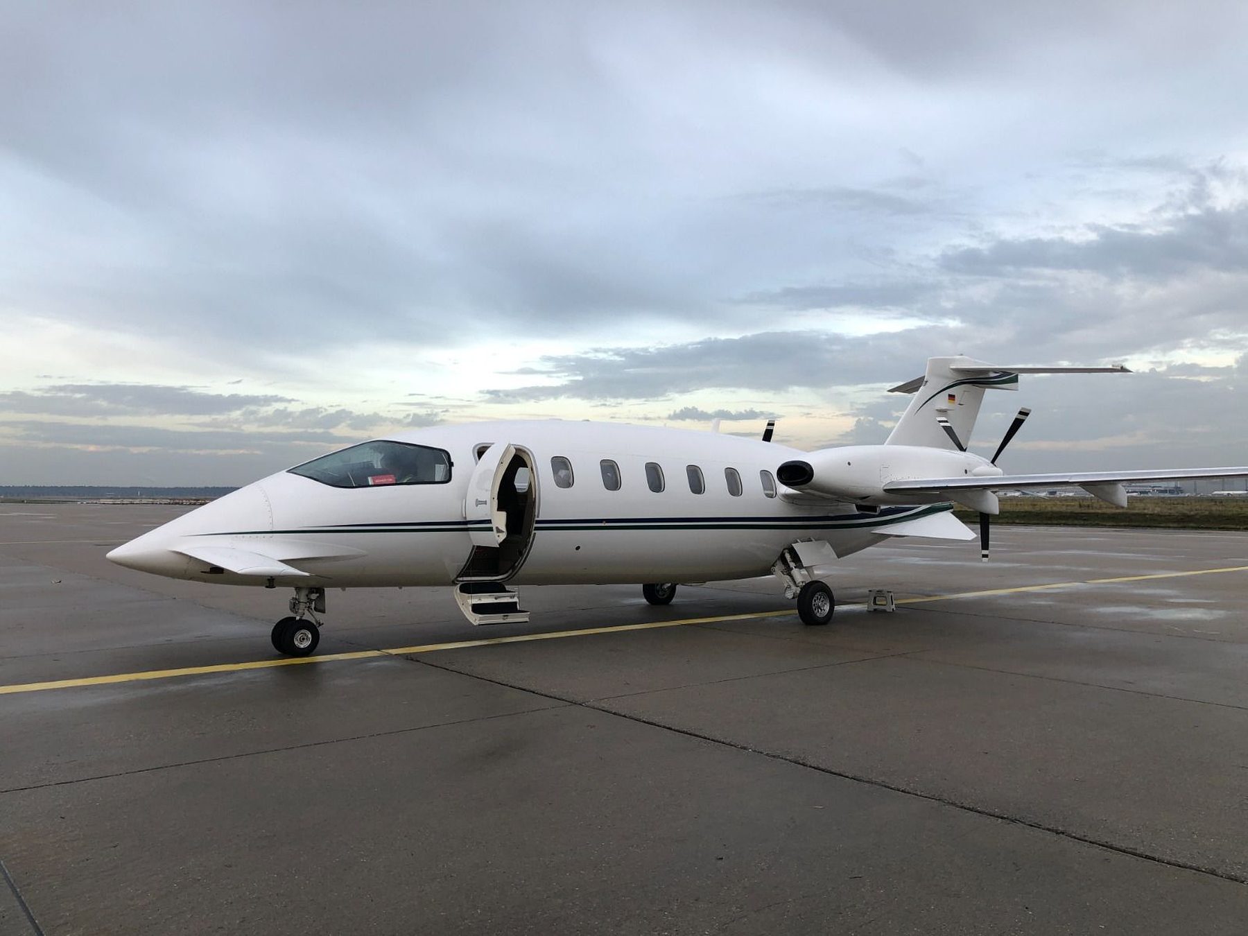 Piaggio P.180 Avanti on the ramp with the airstair door open at dusk